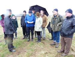 The group and Nicola Nicholls discuss plans for the new National Native Arboretum at Heartwood being planted now close to the location of the plaque.